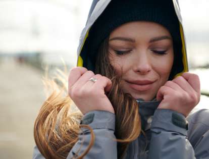 Warm-looking woman in cold conditions wearing a jacket